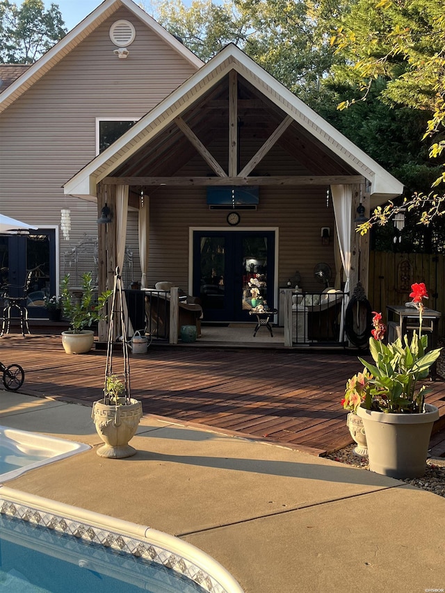 exterior space featuring a deck, french doors, and fence