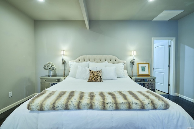 bedroom featuring dark wood-type flooring, beamed ceiling, and baseboards