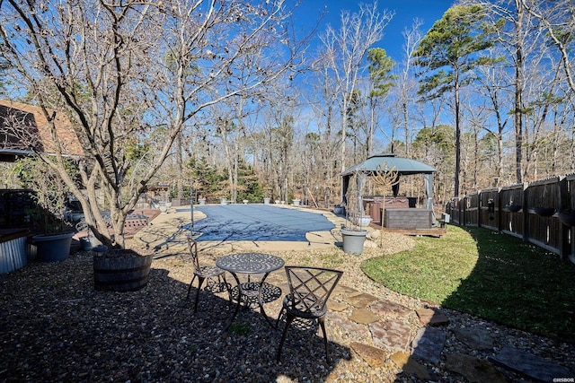 view of yard featuring a patio area, fence, and a fenced in pool