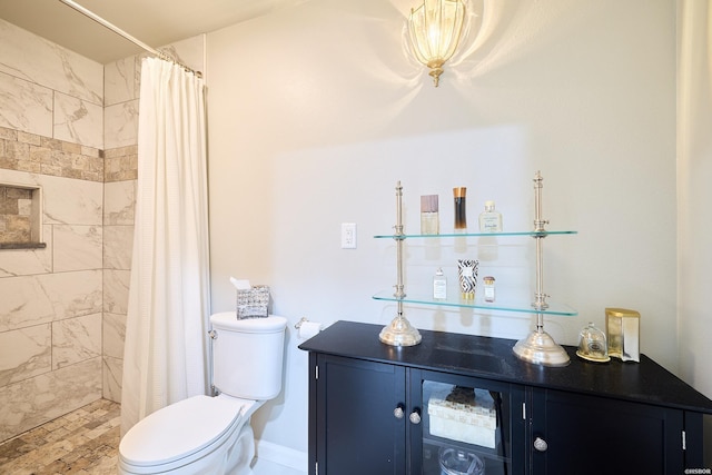 bathroom with toilet and a tile shower