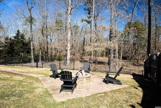 view of yard with a patio area, fence, and a fire pit