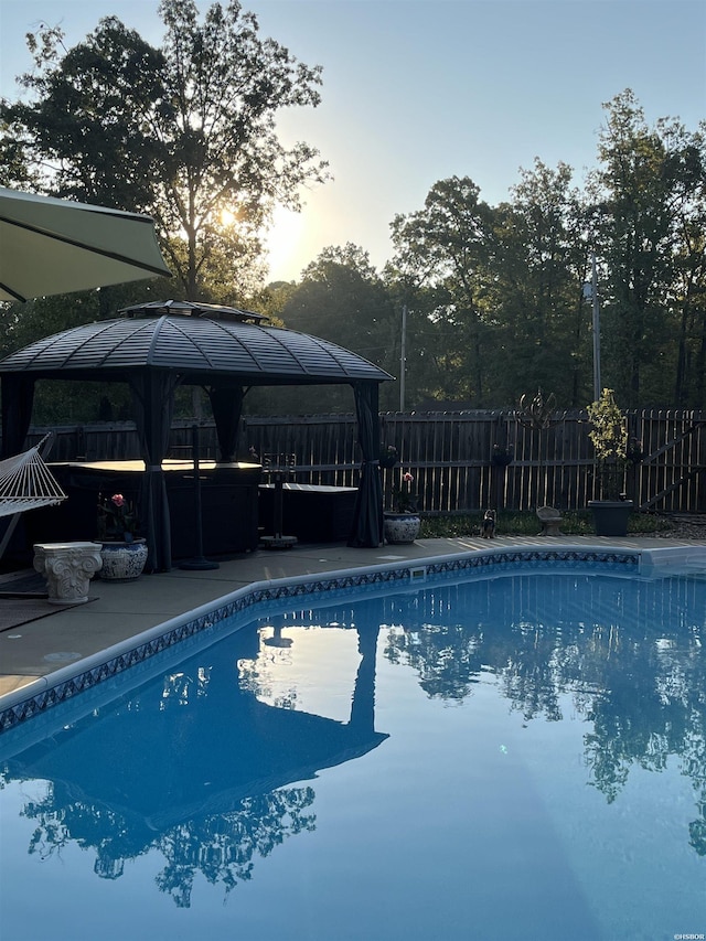 view of pool featuring a gazebo, a patio area, fence, and a fenced in pool