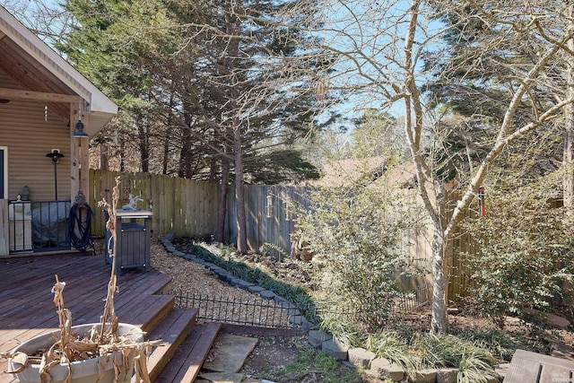 view of yard featuring an outdoor fire pit, fence, and a wooden deck