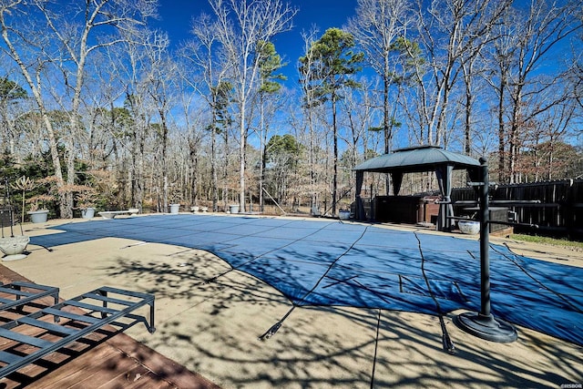 view of swimming pool with a gazebo, a fenced in pool, and a patio