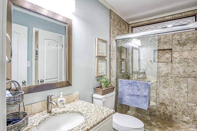 full bath with a textured wall, toilet, crown molding, vanity, and a shower stall