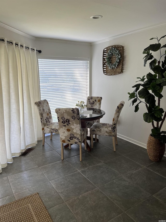 dining room featuring baseboards and crown molding