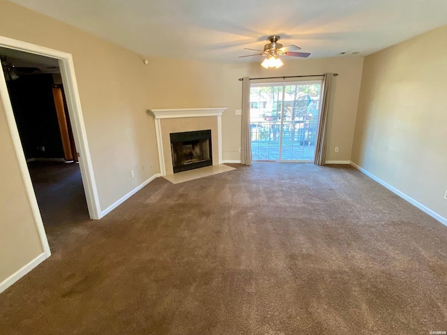 unfurnished living room featuring carpet, a fireplace with flush hearth, and baseboards