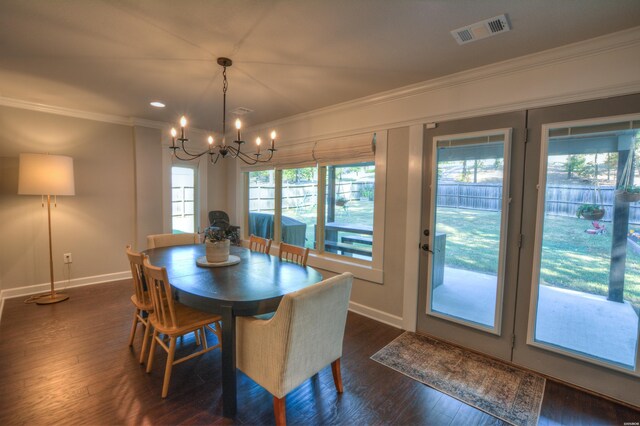 dining area featuring visible vents, dark wood-style flooring, and crown molding