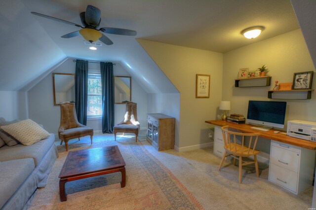 office space with visible vents, baseboards, light colored carpet, lofted ceiling, and ceiling fan