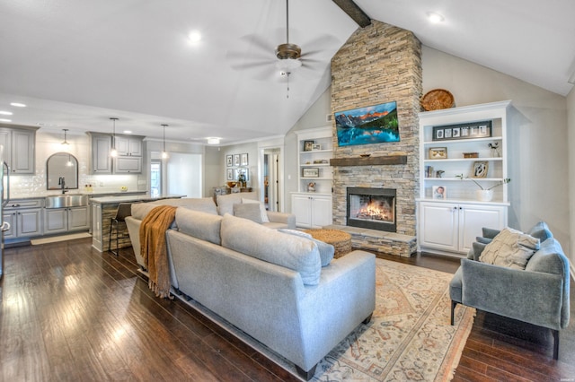 living room featuring high vaulted ceiling, a fireplace, a ceiling fan, dark wood-style floors, and beamed ceiling