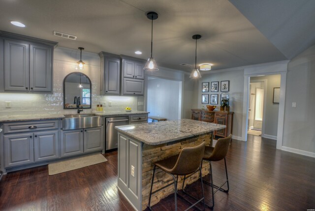 kitchen featuring gray cabinetry, visible vents, pendant lighting, and a center island