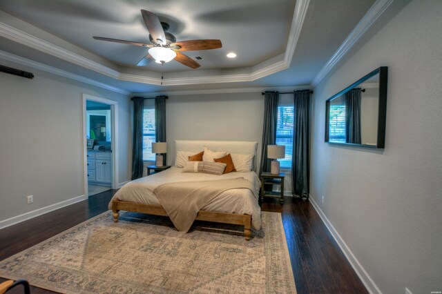 bedroom with a raised ceiling, baseboards, crown molding, and dark wood-style flooring