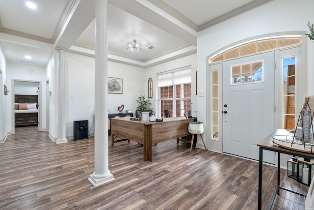 foyer featuring ornamental molding, visible vents, decorative columns, and wood finished floors