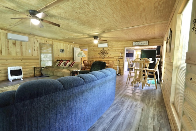 living room with wood ceiling, wood finished floors, heating unit, an AC wall unit, and wood walls