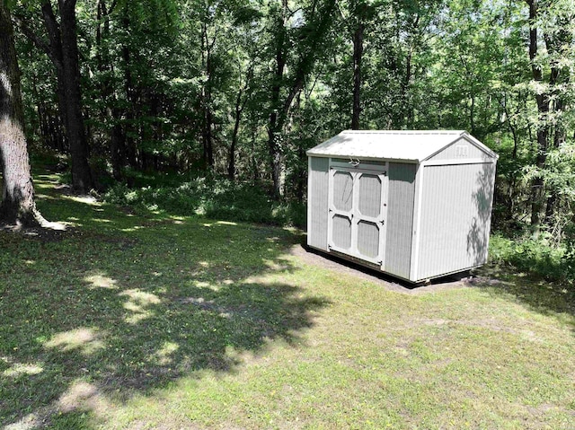 view of yard with a storage shed and an outbuilding