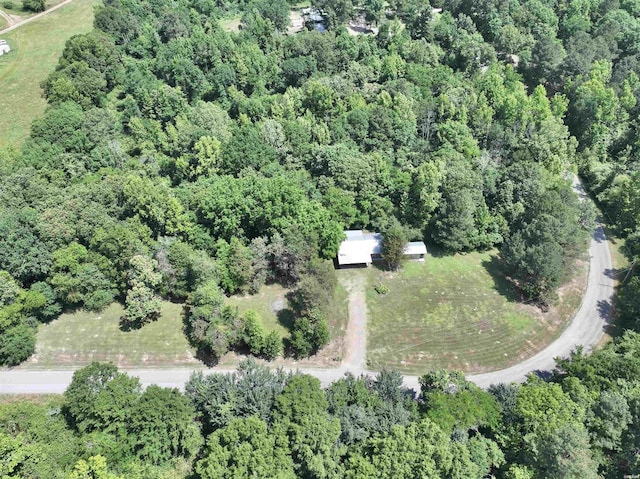 drone / aerial view featuring a forest view