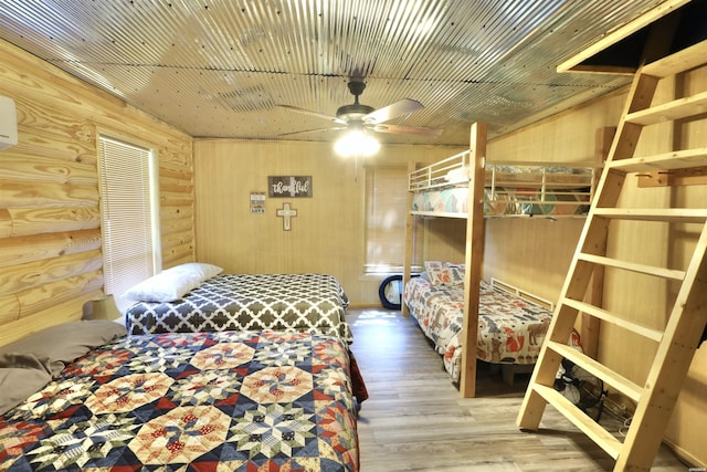 bedroom featuring wood walls and wood finished floors