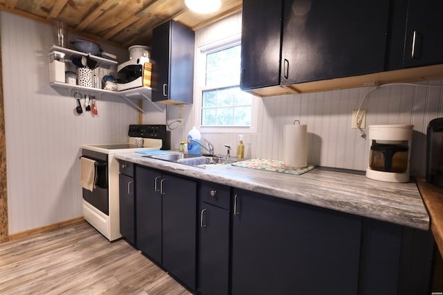 kitchen with white range with electric stovetop, dark cabinetry, light wood-type flooring, open shelves, and a sink