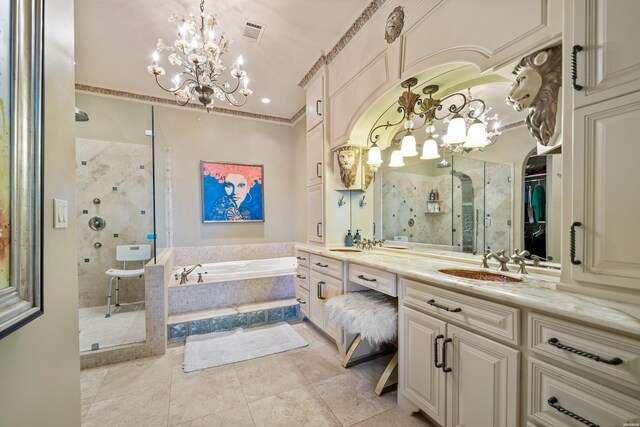 full bath with tile patterned flooring, vanity, a shower stall, a bath, and a walk in closet