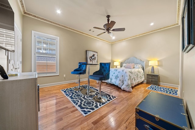 bedroom with light wood finished floors, baseboards, ornamental molding, and a ceiling fan