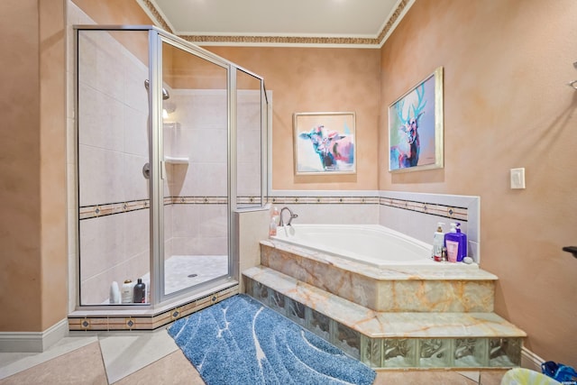 bathroom featuring ornamental molding, a stall shower, a bath, and baseboards