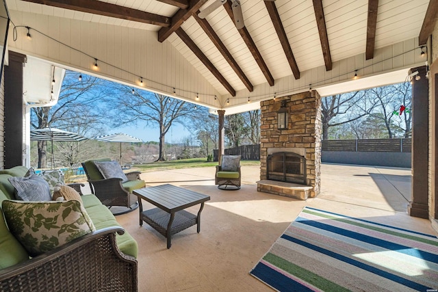 view of patio featuring an outdoor living space with a fireplace and fence