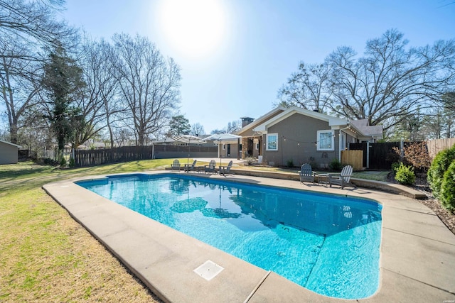 view of swimming pool featuring a yard, a patio, a fenced in pool, and fence