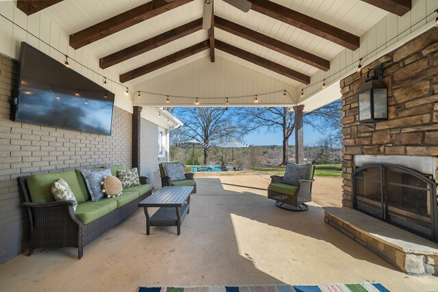 view of patio / terrace with an outdoor living space with a fireplace