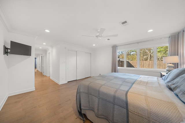 bedroom featuring visible vents, light wood finished floors, recessed lighting, a closet, and crown molding