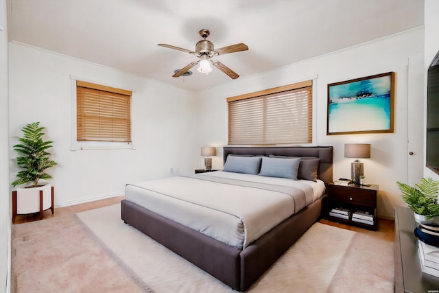 bedroom with crown molding, ceiling fan, and baseboards