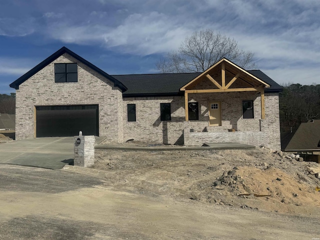 property under construction with brick siding and concrete driveway