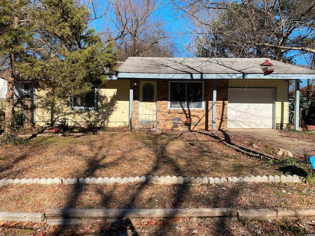 ranch-style house with a garage, driveway, and covered porch