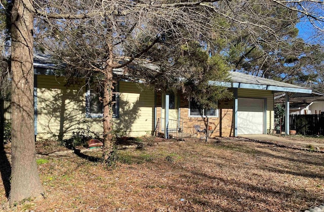 exterior space featuring a garage and dirt driveway