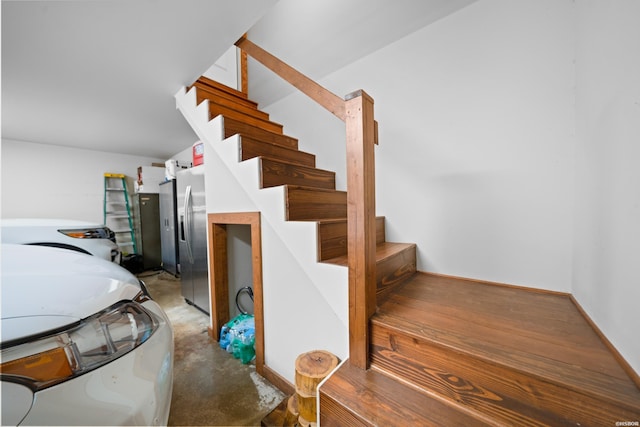 stairway with baseboards and wood finished floors