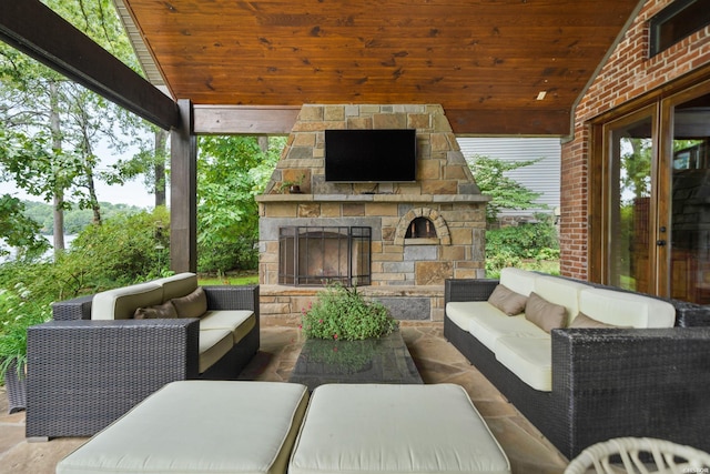 view of patio with an outdoor living space with a fireplace