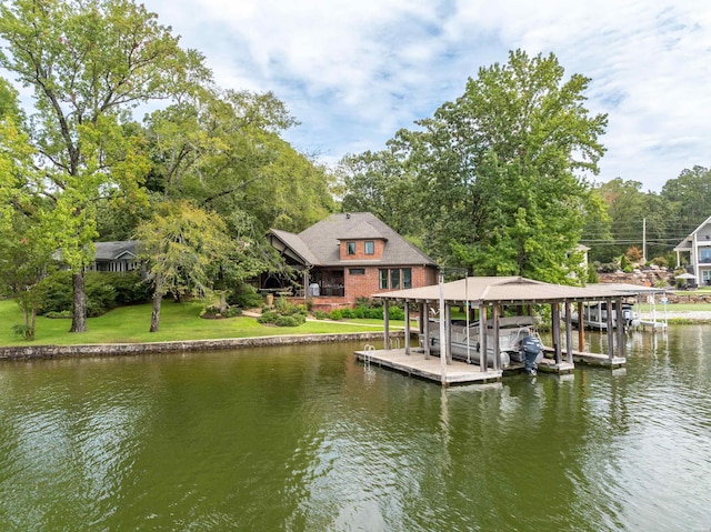 view of dock featuring a water view, a yard, and boat lift