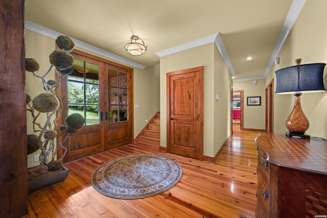 entryway featuring baseboards, stairs, french doors, ornamental molding, and wood-type flooring