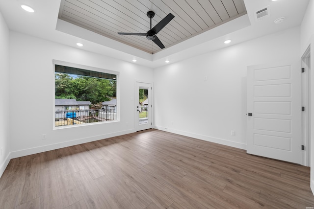 unfurnished room featuring a tray ceiling, wooden ceiling, and visible vents