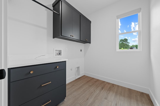 laundry area with washer hookup, cabinet space, light wood-style floors, electric dryer hookup, and baseboards