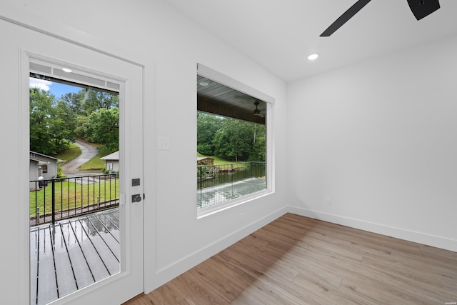 doorway to outside with light wood-type flooring, ceiling fan, baseboards, and recessed lighting