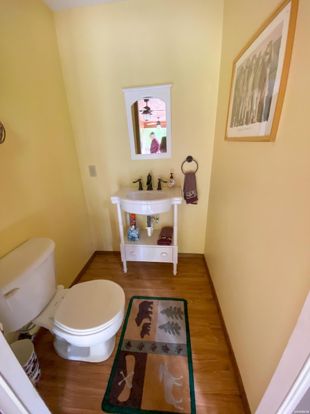 46 Hickory Hill Ln, Mount Ida, AR 71957 - half bathroom with toilet, wood finished floors, a sink, and baseboards