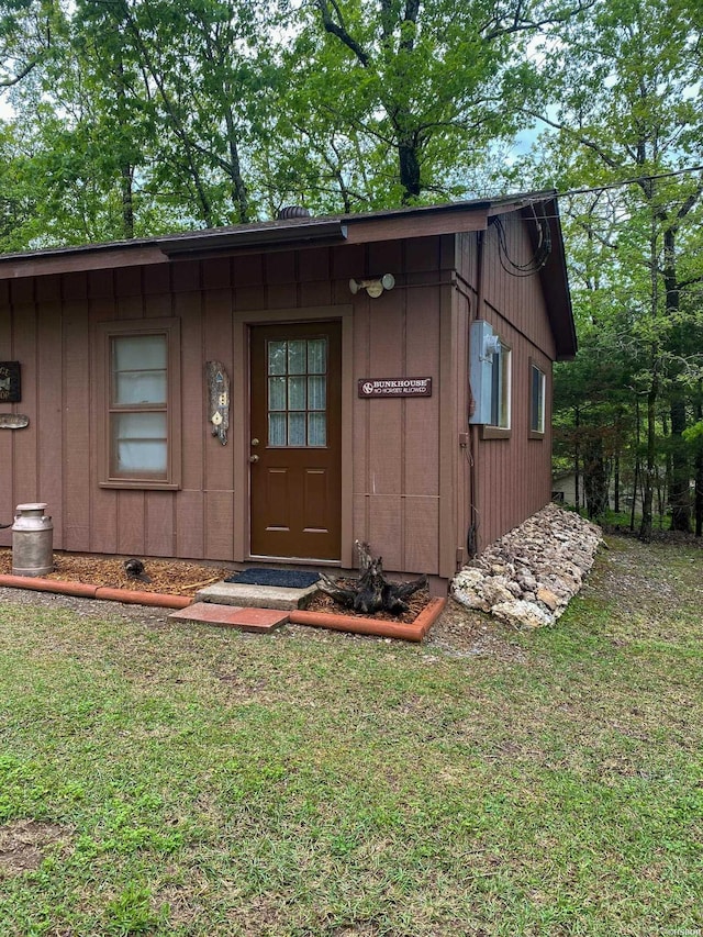 46 Hickory Hill Ln, Mount Ida, AR 71957 - doorway to property with board and batten siding and a yard