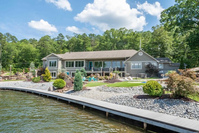 back of property featuring a water view