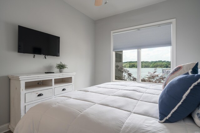 bedroom with a water view, a ceiling fan, and lofted ceiling