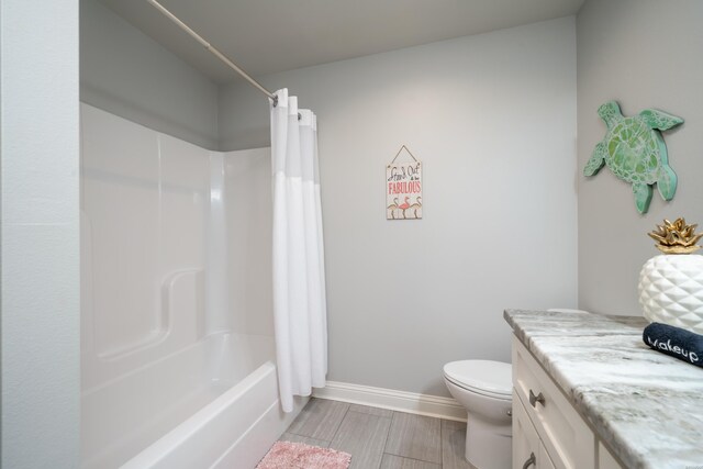 full bath with shower / tub combo, baseboards, toilet, wood tiled floor, and vanity