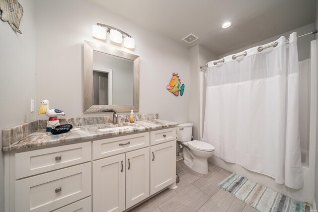 full bath with toilet, shower / tub combo, vanity, and visible vents