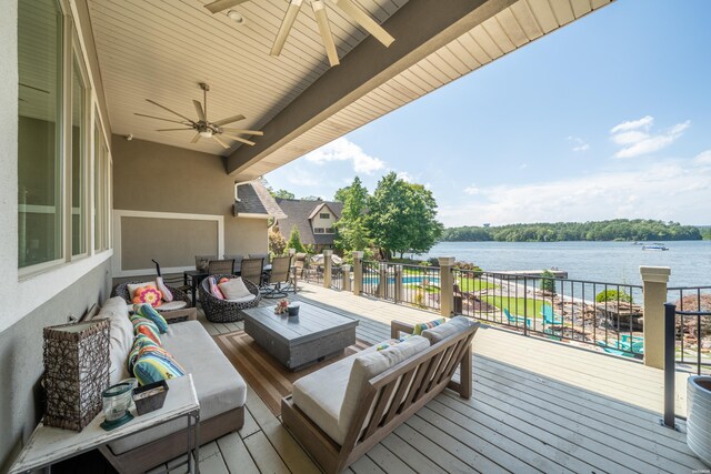 deck with a water view, ceiling fan, and outdoor lounge area