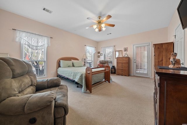 bedroom featuring access to exterior, multiple windows, visible vents, and light colored carpet