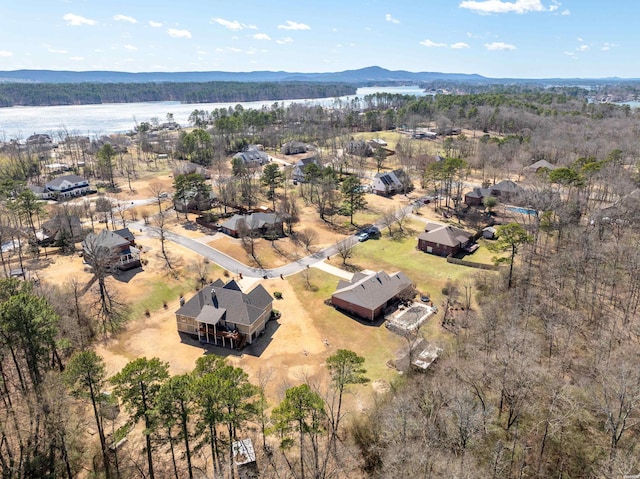 aerial view with a wooded view and a mountain view