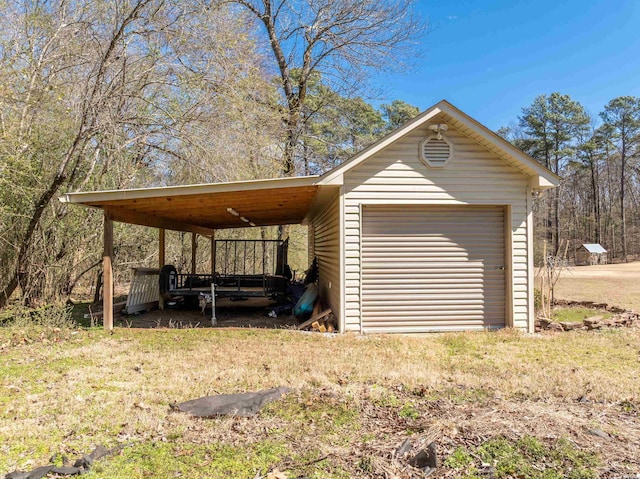 view of outbuilding with an outbuilding, a carport, and driveway